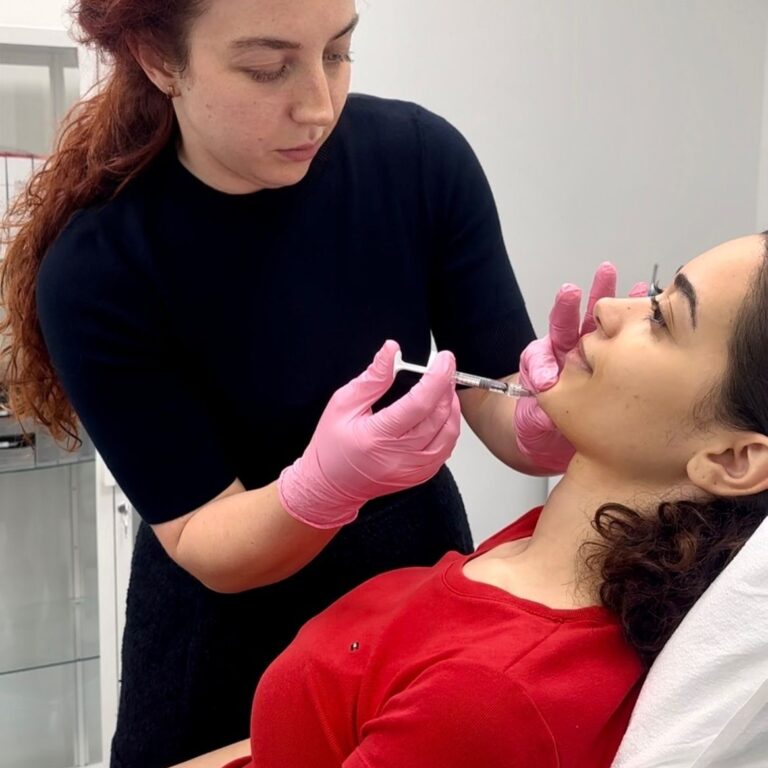 Dr. Elle administering a dermal filler treatment to a patient at Rx Beauty Clinic